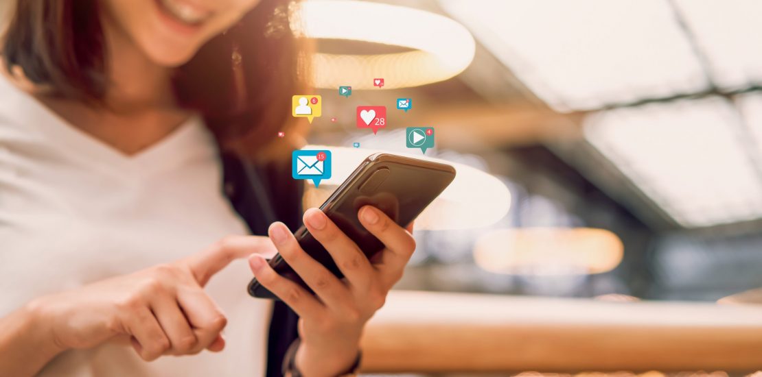 Social media and digital online concept, smiling Asian woman using smartphone and show technology icon. Social media and digital online concept, smiling Asian woman using smartphone and show technology icon.